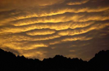 Cumulonimbus clouds at dawn above Norwest Arch, Ben Ohau Range, Southern Alps, New Zealand